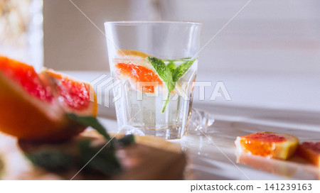 Minimal grapefruit mocktail hero shot with mint garnish and clean copy space Minimal grapefruit mocktail hero shot with mint garnish and clean copy space 141239163