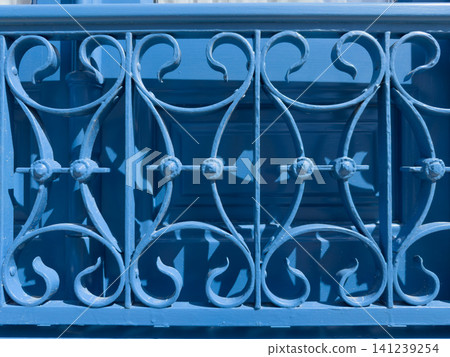 Vivid Blue Ornate Ironwork Balcony Detail Vivid Blue Ornate Ironwork Balcony Detail 141239254