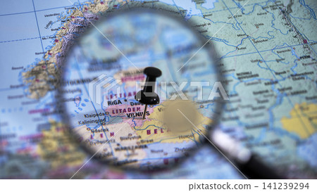 Explore vilnius with a close-up view of a printed map and magnifying glass Explore vilnius with a close-up view of a printed map and magnifying glass 141239294