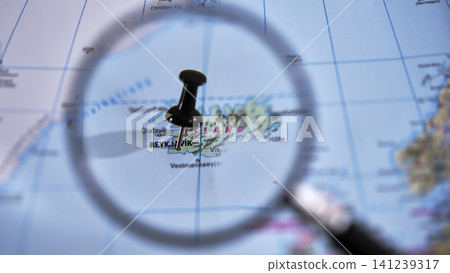 Reykjavik marked on a printed map, using a magnifying glass. Reykjavik marked on a printed map, using a magnifying glass. 141239317