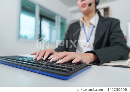 Close up of hands typing on keyboard in office for data entry Close up of hands typing on keyboard in office for data entry 141239606