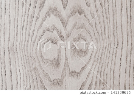 Full frame background texture of a light grey natural oak wood board with a beautiful symmetrical ring grain pattern and knots visible on a polished surface Full frame background texture of a light grey natural oak wood board with a beautiful symmetrical ring grain pattern and knots visible on a polished surface 141239655