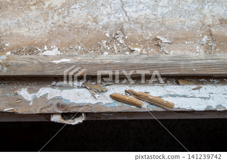 Old Wooden Window Frame with Partially Stripped Paint 141239742