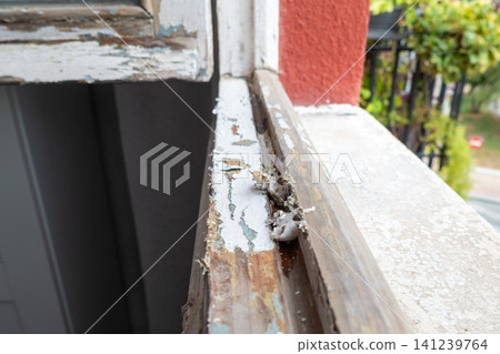 Old Wooden Window Frame with Partially Stripped Paint 141239764