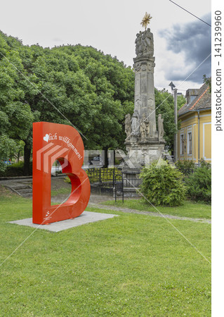 Bataszek welcome sign letter B and Holy Trinity Column Bataszek welcome sign letter B and Holy Trinity Column 141239960