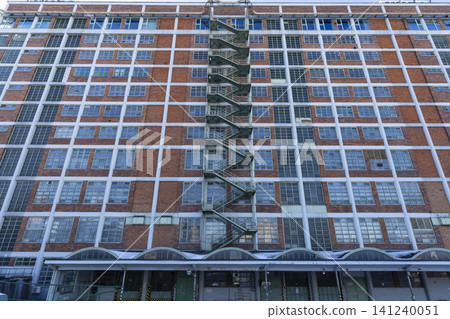 Zlin industrial building with repeating window grid and fire escape Zlin industrial building with repeating window grid and fire escape 141240051