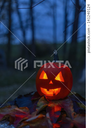 Jack o' lantern glowing in eerie Halloween night Jack o' lantern glowing in eerie Halloween night 141240124