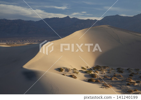 Desert Sand Dune Landscape with Mountains and Blue Sky Desert Sand Dune Landscape with Mountains and Blue Sky 141240199
