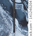 Aerial Winter Road Bridge Over Frozen River with Car 141240204