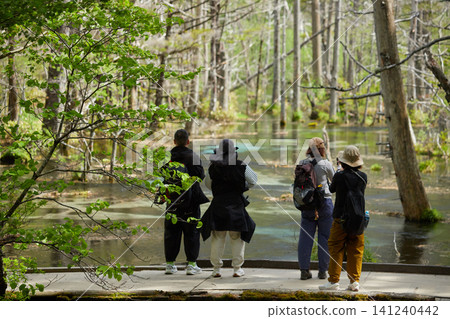 Scenes of the lush green forests and tourists in Kamikochi, a popular tourist spot in early summer. Scenes of the lush green forests and tourists in Kamikochi, a popular tourist spot in early summer. 141240442