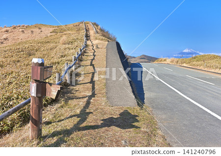 Izu Ridge Trail on the Izu Peninsula: Entrance to Funahara Pass at Nishina Pass, showing the ridge trail, road, and Mount Fuji. Izu Ridge Trail on the Izu Peninsula: Entrance to Funahara Pass at Nishina Pass, showing the ridge trail, road, and Mount Fuji. 141240796