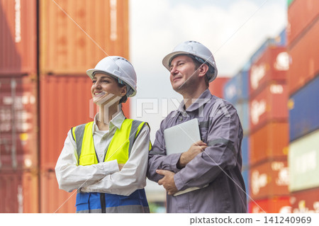 Two engineer standing in front of cargo container with concept of successful in shipping workplace. Two engineer standing in front of cargo container with concept of successful in shipping workplace. 141240969