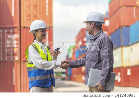 Business Team Cargo Container Shipping Inspection. Import and Export Freight at Port. Successful and accomplished work of teamwork Inspecting Containers Shipment. Shake hand and smile worker. Business Team Cargo Container Shipping Inspection. Import and Export Freight at Port. Successful and accomplished work of teamwork Inspecting Containers Shipment. Shake hand and smile worker. 141240993