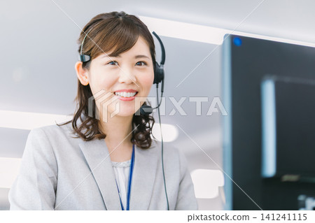 Female operator working at a call center Female operator working at a call center 141241115
