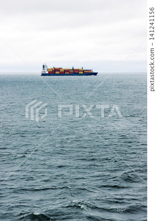 Container ship crossing Baltic sea between Helsinki and Tallinn. Minimal maritime landscape with copy space Container ship crossing Baltic sea between Helsinki and Tallinn. Minimal maritime landscape with copy space 141241156