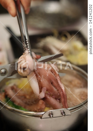 Octopus Being Prepared in Cooking Pot Octopus Being Prepared in Cooking Pot 141241202