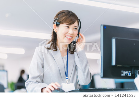 Female operator working at a call center Female operator working at a call center 141241553