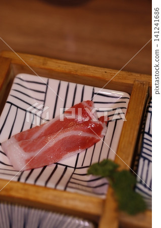 Fresh Sliced Raw Meat on Traditional Plate Fresh Sliced Raw Meat on Traditional Plate 141241686
