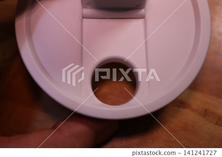 Close-up of Toilet Seat with Hand Holding Close-up of Toilet Seat with Hand Holding 141241727