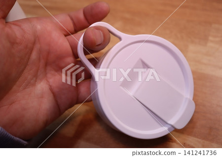 Hand Holding White Container Lid with Flip Top Hand Holding White Container Lid with Flip Top 141241736