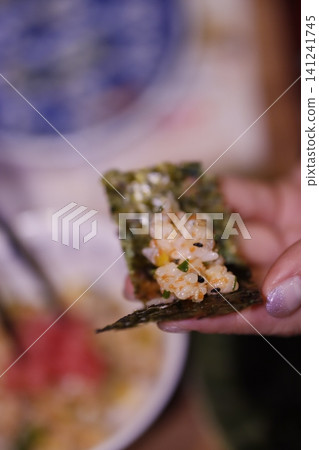Hand Holding Seaweed Rice Snack Close-Up Hand Holding Seaweed Rice Snack Close-Up 141241745