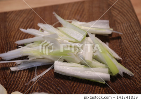 Chopped Scallions on Wooden Cutting Board 141241819
