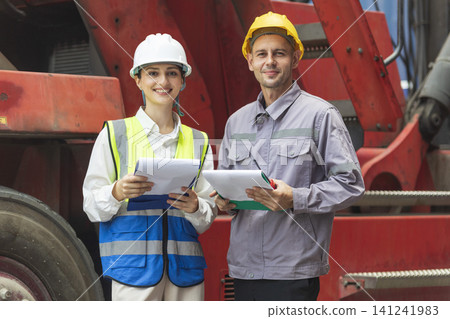 Two engineers discussing project together with construction worker outdoors Two engineers discussing project together with construction worker outdoors 141241983