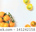 Yellow and orange cherry tomatoes against a white background 141242158