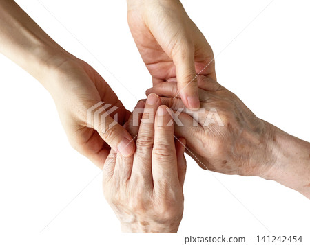 A woman's hand holding the hand of an elderly woman, against a white background. A woman's hand holding the hand of an elderly woman, against a white background. 141242454