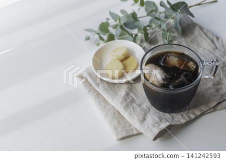 A natural café time with iced coffee and cookies placed on a linen cloth. A natural café time with iced coffee and cookies placed on a linen cloth. 141242593