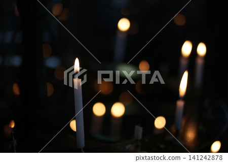 The flames of votive candles flicker in the grounds of Senso-ji Temple, creating a fantastical, flickering candle light. The flames of votive candles flicker in the grounds of Senso-ji Temple, creating a fantastical, flickering candle light. 141242878