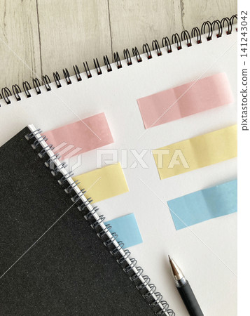 Business and life planning idea generation sketchbook/ring notebook with 3 colors of sticky notes, pen, and workspace. Business and life planning idea generation sketchbook/ring notebook with 3 colors of sticky notes, pen, and workspace. 141243042