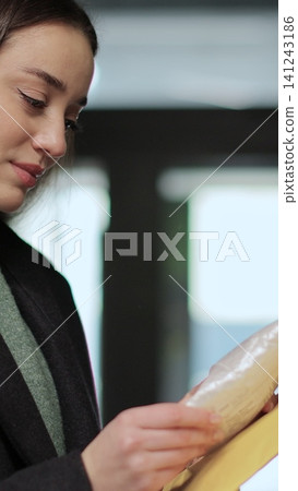 Vertical video Young woman opening and checking mailbox in apartment building. Mail shipping concept. Vertical video Young woman opening and checking mailbox in apartment building. Mail shipping concept. 141243186