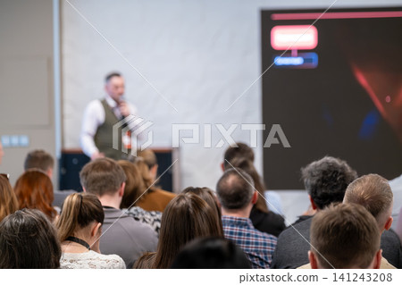 Business conference presentation with attentive audience listening to speaker in corporate seminar setting Business conference presentation with attentive audience listening to speaker in corporate seminar setting 141243208