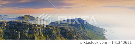 Mountain, island and clouds on sunset sky at ocean with natural landscape, hill and beach at travel banner. Nature, fog and sustainable environment with earth, sea and tropical holiday destination Mountain, island and clouds on sunset sky at ocean with natural landscape, hill and beach at travel banner. Nature, fog and sustainable environment with earth, sea and tropical holiday destination 141243631