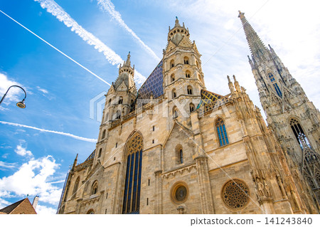 Austria, Vienna: St. Stephen's Cathedral, a Gothic architectural masterpiece, stands out against the blue sky. Austria, Vienna: St. Stephen's Cathedral, a Gothic architectural masterpiece, stands out against the blue sky. 141243840