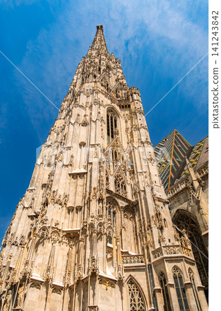 Vienna, Austria: The south tower (spire) of St. Stephen's Cathedral soars towards the blue sky. 141243842