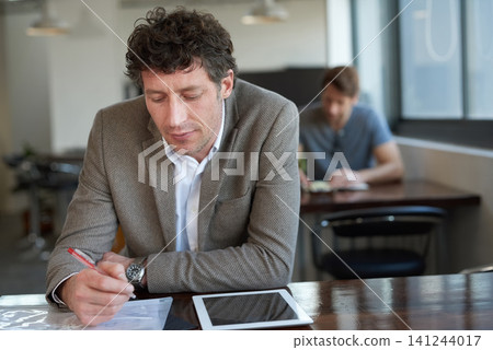 Tablet, auditor and man with document, writing and report of stock market on desk of workplace. Office, staff and male person working for business, paper and budget of corporate company for economy Tablet, auditor and man with document, writing and report of stock market on desk of workplace. Office, staff and male person working for business, paper and budget of corporate company for economy 141244017