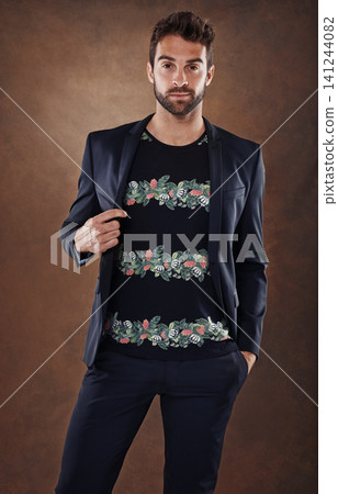 Spanish male, model and fashion portrait in studio, stylish and isolated on brown background. Clothing, confidence and backdrop space with pose, casual and trendy outfits for cool mens apparel. Spanish male, model and fashion portrait in studio, stylish and isolated on brown background. Clothing, confidence and backdrop space with pose, casual and trendy outfits for cool mens apparel. 141244082