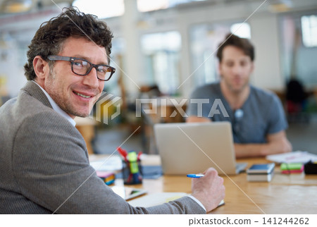 Happy, portrait and creative man coworking in office with team and planning project with notes on desk. Mature, employee and productivity in collaboration, cooperation or writing ideas in proposal Happy, portrait and creative man coworking in office with team and planning project with notes on desk. Mature, employee and productivity in collaboration, cooperation or writing ideas in proposal 141244262