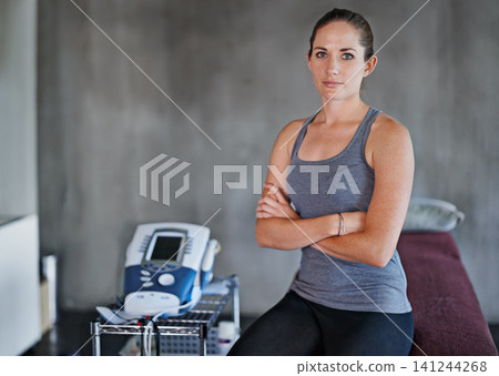 Portrait, woman and physio in studio for health with massage table for fitness, rehab and confidence. Female person, chiropractor and machine in clinic for wellness with muscles and electrotherapy Portrait, woman and physio in studio for health with massage table for fitness, rehab and confidence. Female person, chiropractor and machine in clinic for wellness with muscles and electrotherapy 141244268