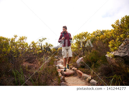 Hiking, nature walk and man with backpack, travel and adventure outdoor on mountain path with plants. Journey, fitness and thinking with camping gear and bag for exercise and explorer with training Hiking, nature walk and man with backpack, travel and adventure outdoor on mountain path with plants. Journey, fitness and thinking with camping gear and bag for exercise and explorer with training 141244277