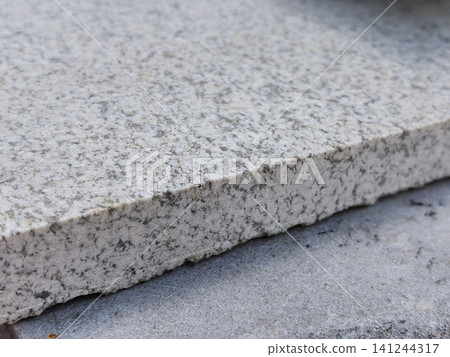 Gray granite stone slab edge closeup natural speckled texture background Gray granite stone slab edge closeup natural speckled texture background 141244317