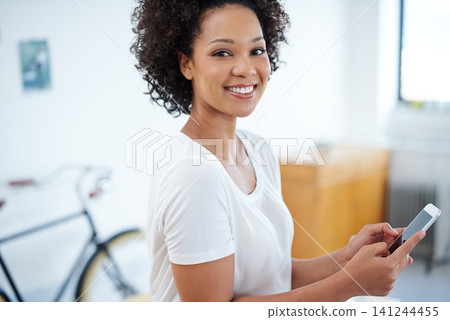 Business woman, phone and smile in office for social media, chat and communication in creative job or public relations. Portrait of an African worker, employee or person typing on mobile for contact Business woman, phone and smile in office for social media, chat and communication in creative job or public relations. Portrait of an African worker, employee or person typing on mobile for contact 141244455