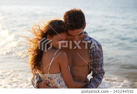 Sunshine, couple hug on beach and ocean, travel for anniversary or date with bonding, love and support. Affection, peace and fresh air in nature, people outdoor with trust and care in relationship Sunshine, couple hug on beach and ocean, travel for anniversary or date with bonding, love and support. Affection, peace and fresh air in nature, people outdoor with trust and care in relationship 141244592