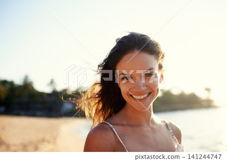 Travel, beach and portrait of woman in summer for vacation, holiday and weekend outdoors. Nature, happy and face of person smile for relaxing, adventure and destination by ocean on tropical island 141244747