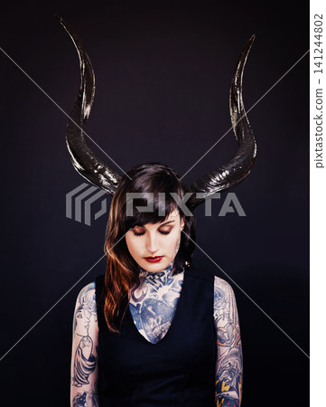 Woman, horns and tattoo for costume, cosplay and creative with ink for design, picture and symbol. Young person and ears for art and bold for statement, funky and edgy or unique on dark background Woman, horns and tattoo for costume, cosplay and creative with ink for design, picture and symbol. Young person and ears for art and bold for statement, funky and edgy or unique on dark background 141244802