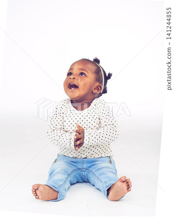 Black baby, girl or excited to relax, laugh or vision for clapping, funny or idea on white background. Toddler, smile or on floor to imagine, curiosity or wonder of childhood on studio mock up Black baby, girl or excited to relax, laugh or vision for clapping, funny or idea on white background. Toddler, smile or on floor to imagine, curiosity or wonder of childhood on studio mock up 141244855