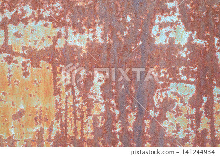 Rusted metal plate texture with cracked paint, vintage orange and brown iron surface with heavy corrosion streaks background Rusted metal plate texture with cracked paint, vintage orange and brown iron surface with heavy corrosion streaks background 141244934