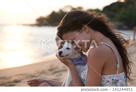 Woman, pet and beach with friendship, smile and happy for wellness, travel and journey on island. Female person, cheerful and dog for vacation, holiday and outdoor in coastal, tropical and summer Woman, pet and beach with friendship, smile and happy for wellness, travel and journey on island. Female person, cheerful and dog for vacation, holiday and outdoor in coastal, tropical and summer 141244951